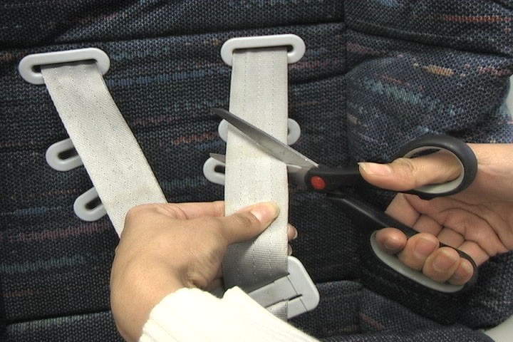 Cutting off harness straps of car seat
