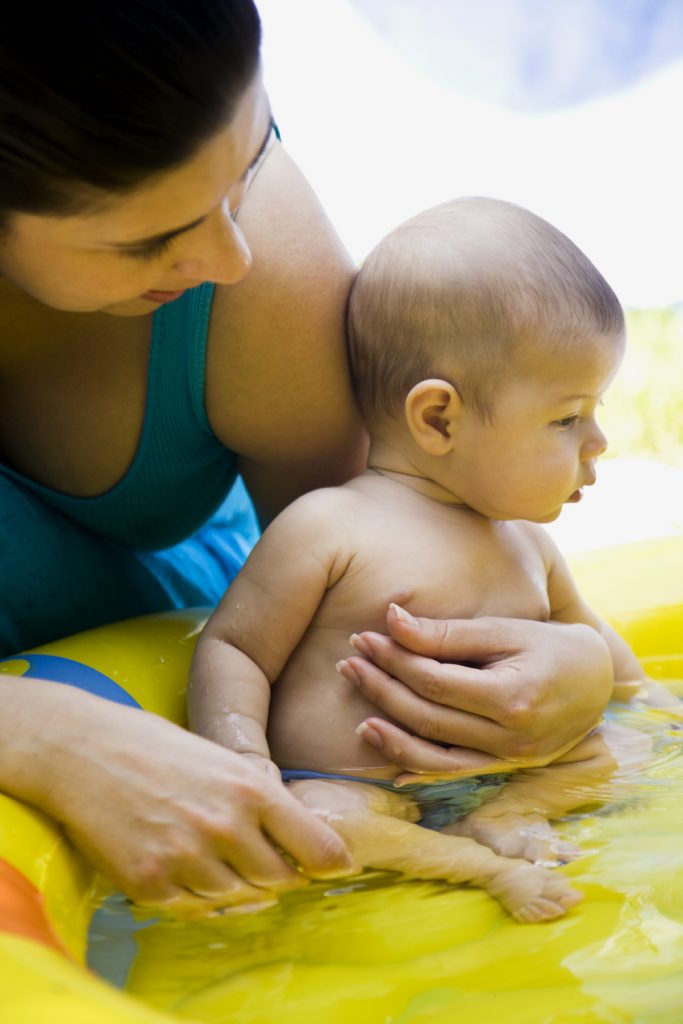 Mother holding baby in Kiddie Pool